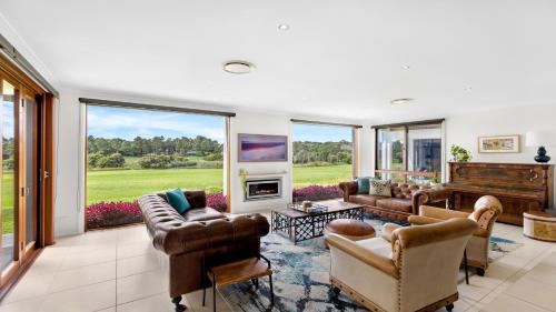 a living room filled with furniture and a piano at Peppertree Ponds in Pokolbin