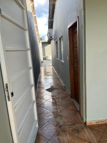 a hallway with a door and a tiled floor at Suíte com sala de estar in Porto Velho