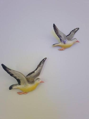 two birds are flying on a white background at That Retro Place Kiama in Kiama