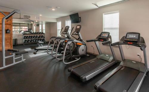 a gym with several tread machines in a room at Sleepover 1BD 1BA Little Rock Apartments in North Little Rock