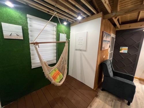 a room with a hammock hanging from a wall at VSS Beach House - Arecibo in Arecibo