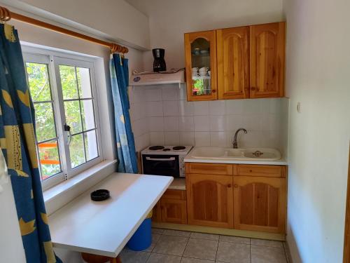 a small kitchen with a sink and a stove at CottonClub Villas in Tolo