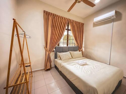 a bedroom with a bed and a window with a fan at JB GatheringHouse Bungalow 5Bedroom 12pax in Johor Bahru