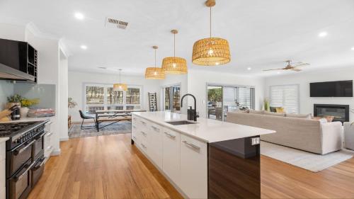 an open kitchen and living room with a couch at Hunter Dreaming in Pokolbin
