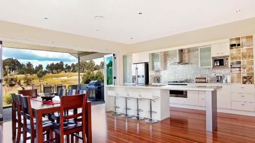 a kitchen and dining room with a table and chairs at Dashaz Dream - The Vintage in Pokolbin