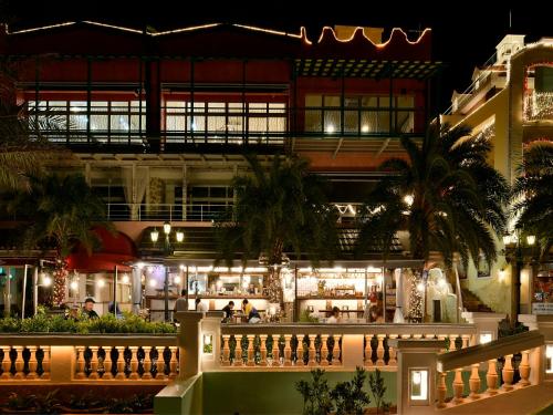 a building with a bar in front of it at night at Vessel Hotel Campana Okinawa in Chatan