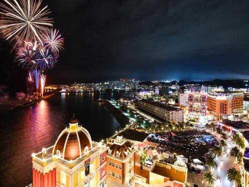 a view of a city at night with fireworks at Vessel Hotel Campana Okinawa in Chatan