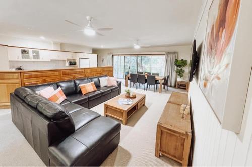 a living room with a couch and a table at Paringa Riverside Resort in Renmark