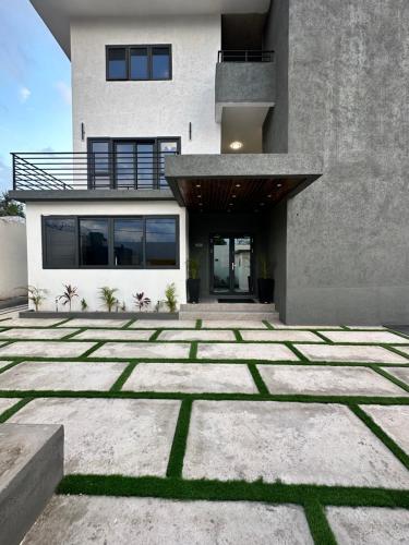 a house with a stone courtyard in front of it at White Signature Suite in Kingston