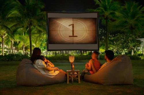 a group of people sitting on bean bags watching a tv at Melia Ho Tram Beach Resort in Ho Tram