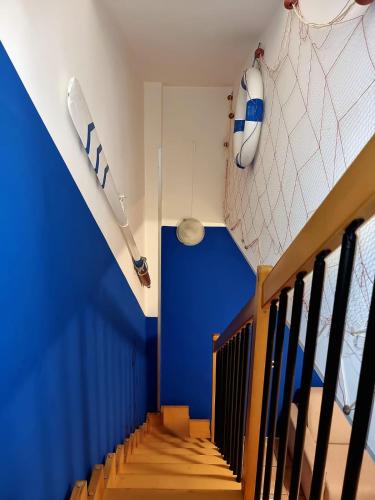 a room with a staircase with a boat on the wall at Al mare da Iva in Duna Verde