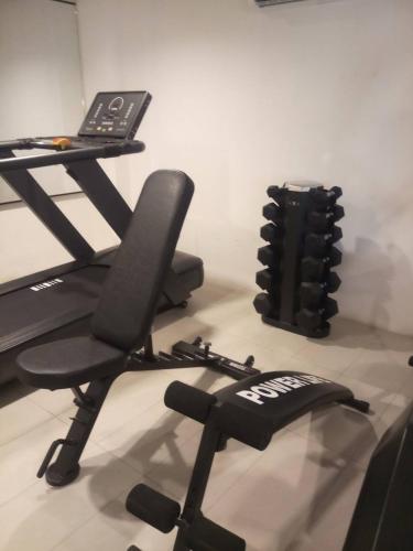 a treadmill and a desk with a laptop on it at The Guest Hotel & Hostel in Chiang Mai