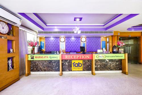 a reception desk in an office with a reception counter at FabHotel Prime Mahalaya Residency in Chennai