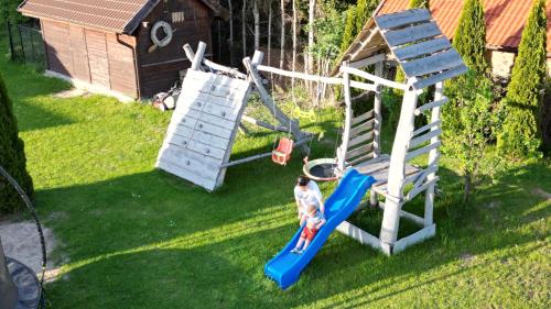 an aerial view of a child playing on a playground at Bajkowe Domki Marzeń Krecik in Węgorzewo