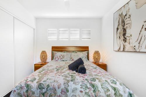 a bedroom with a bed and two night stands at Elvis on Brodie - luxury boutique accommodation in Coffs Harbour