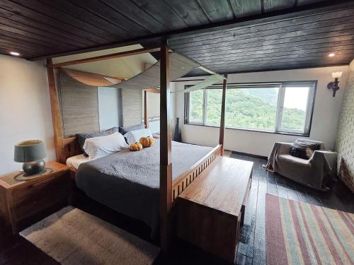 a bedroom with a bed and a large window at 金石新月光 in Jiufen