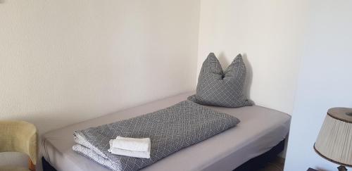 two pillows sitting on a bed in a room at Pension Rudolph Riesa in Riesa