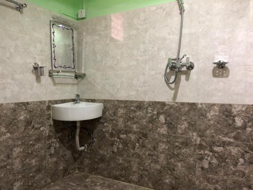 a bathroom with a sink and a mirror on the wall at Wander Thirst in Kathmandu