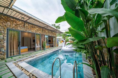 een zwembad met noedels in een huis met planten bij FreePickUp Pool 5 BRs Villa,5 Mins Walk to Beach in Da Nang