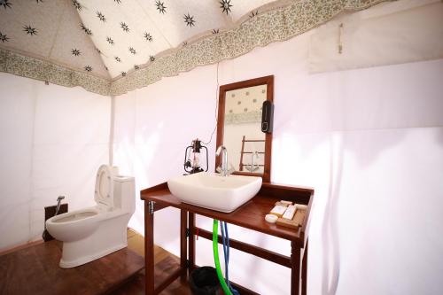 a bathroom with a sink and a toilet at Shivadya Camps MAHAKUMBH Mela in Allahābād