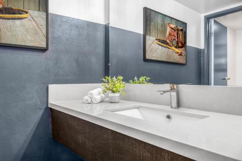 a bathroom with a white sink and a mirror at The Angler Lodge in Dunsmuir