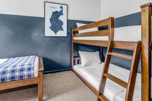 a bedroom with two bunk beds and a ladder at The Angler Lodge in Dunsmuir