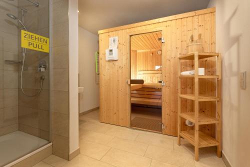 a bathroom with a shower and a shower stall at Ski in/Ski out Chalets Tauernlodge by Schladming-Appartements in Schladming