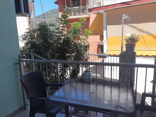 a table and chairs sitting on a balcony at Paraskevi's Luxury Studios in Parga