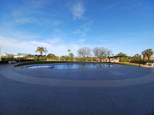 a large pool in the middle of a park at Atardecer en Torre la Sal in Castellón de la Plana