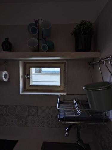 a kitchen with a window and a pot on a stove at Al Porticciolo di Savelletri in Savelletri di Fasano