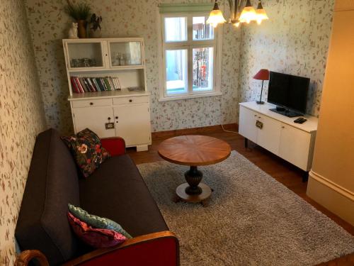 a living room with a couch and a table at Romantic Seaside House in Pärnu