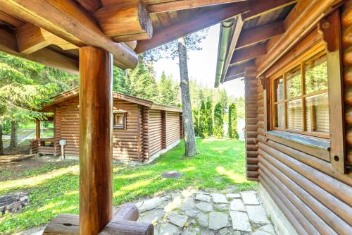 a log cabin with a porch and a window at Villas Jagoda & Malina in Borovets
