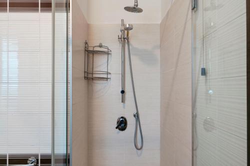 a shower with a glass door in a bathroom at Sara al Lago - con garage e WiFi in Sirmione
