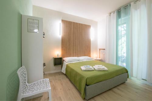 a bedroom with a bed with a chair and a window at B&B Al Parco in Verona
