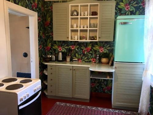 a kitchen with a stove and a refrigerator at Romantic Seaside House in Pärnu