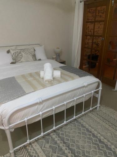 a bedroom with a bed with towels on it at Riverside Boutique Apartment in Rockhampton