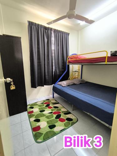 a bedroom with a bunk bed and a rug at Putra 2 Homestay in Gua Musang