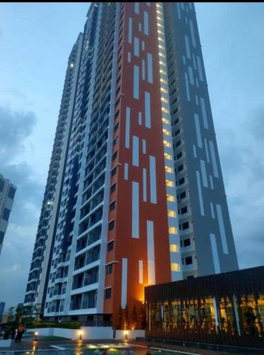 a large tall building with lights on the side of it at Meritus Suites - 8pax in Perai