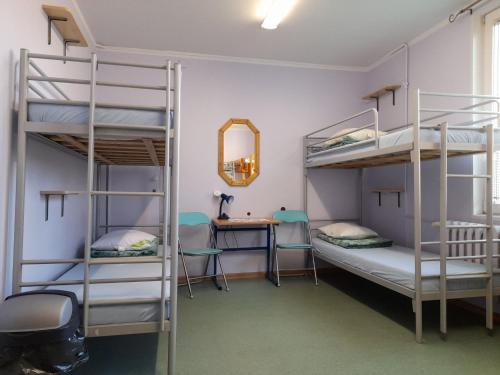 a room with three bunk beds and a desk at Youth Hostel Podlasie in Białystok