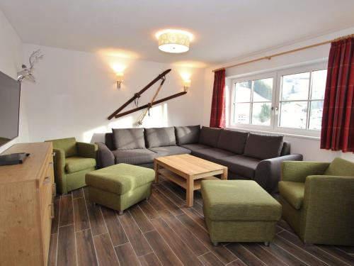 a living room with a couch and chairs and a table at Modern chalet with sauna near ski area in Saalbach Hinterglemm Salzburgerland in Saalbach-Hinterglemm
