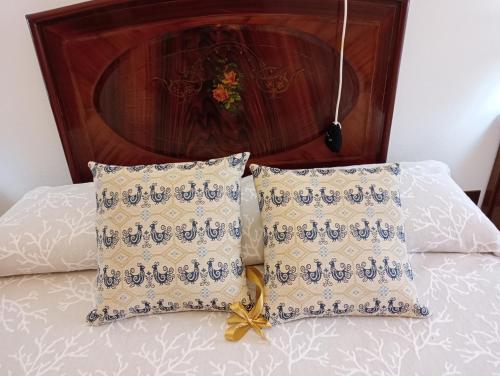 a bed with two pillows on top of it at CasaFigus La Terrazza NARBOLIA in Narbolia