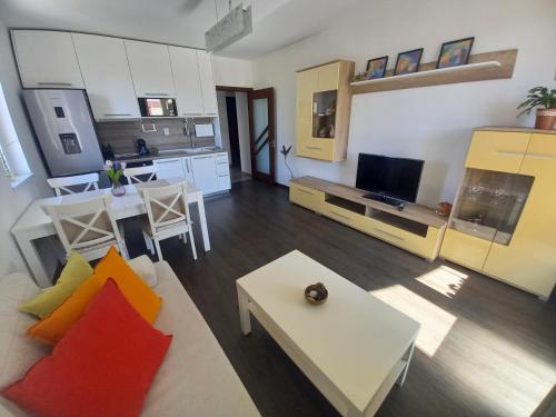 a living room with a couch and a table at Happy Apartment & Free Breakfast - Mladost in Sofia