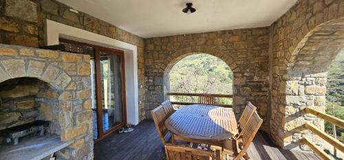 a stone room with a table and chairs on a porch at Villa Toscana in Gokceada Town