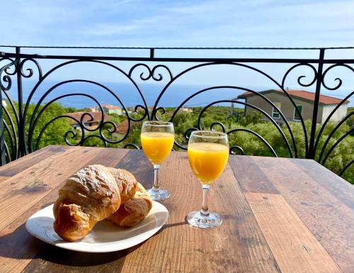 a table with two glasses of orange juice and croissants at Krimovica Sunset in Krimovice