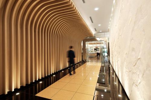 a man walking down a hallway in a shopping mall at Nilai Springs Resort Hotel in Nilai