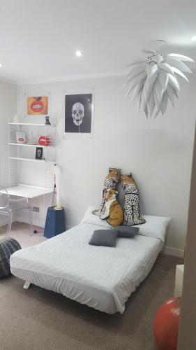a bedroom with a bed with two stuffed animals on it at Family Home with fast trains to London Bridge, Victoria, Gatwick and Wimbledon in Croydon