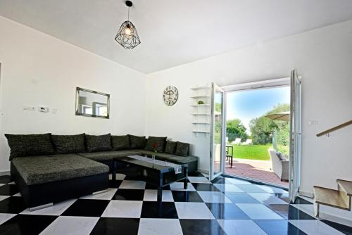 un soggiorno con divano e pavimento a scacchi di Casa Lavanda Vrsar shared Pool a Vrsar