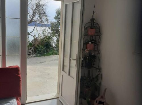 an open door with a view of a patio at Apartment Sanja in Slano