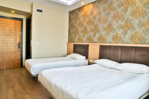 Ένα ή περισσότερα κρεβάτια σε δωμάτιο στο Start Hotel