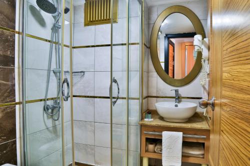 a bathroom with a sink and a shower at Start Hotel in Antalya